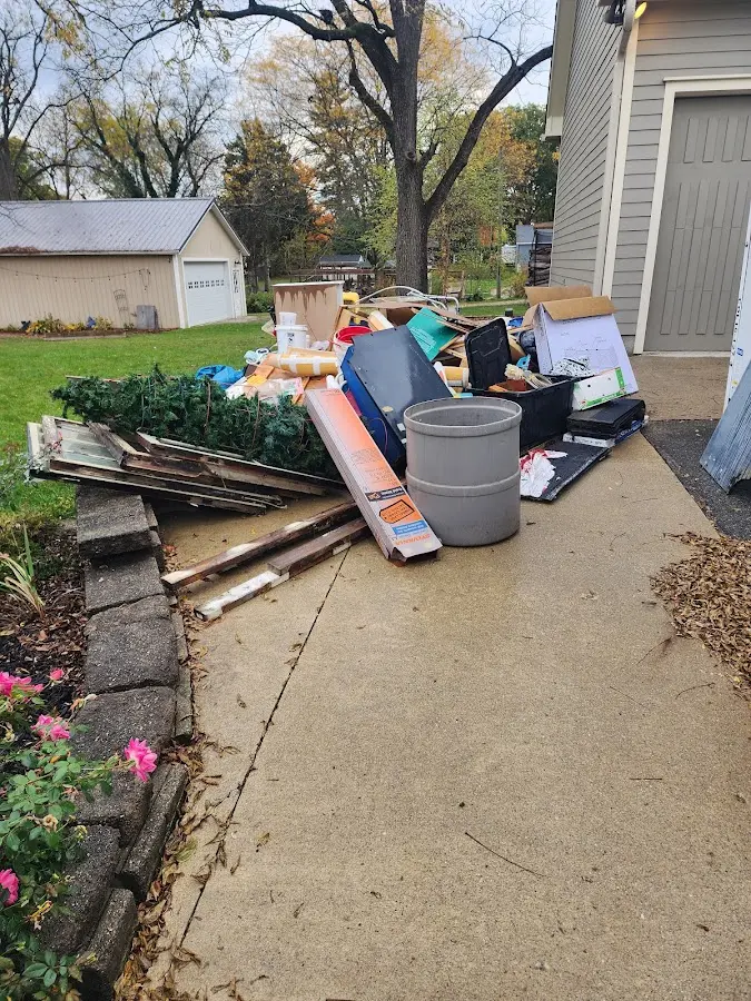 Dumpster being loaded with debris for Estate Cleanout Dumpster Rental in Warm Beach